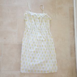 white dress with green and yellow leaf pattern